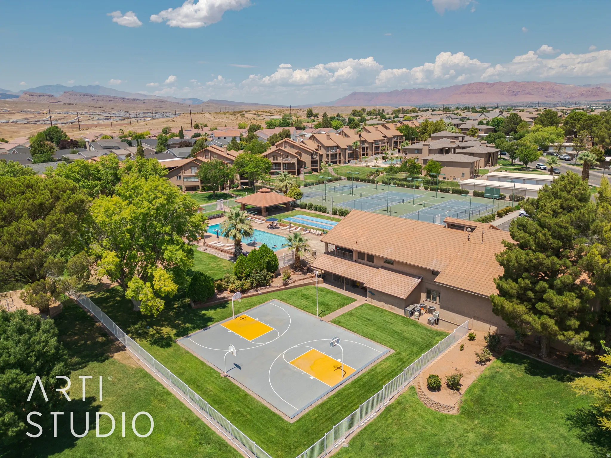 Aerial perspective of suburban area with mountains and a pool area