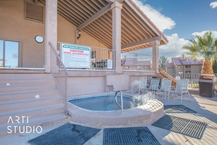 View of swimming pool with grilling area, patio surround, and a hot tub