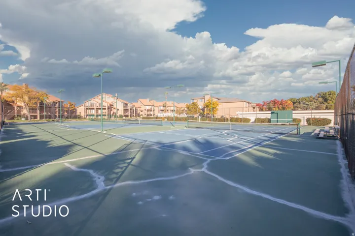View of tennis court featuring a residential view