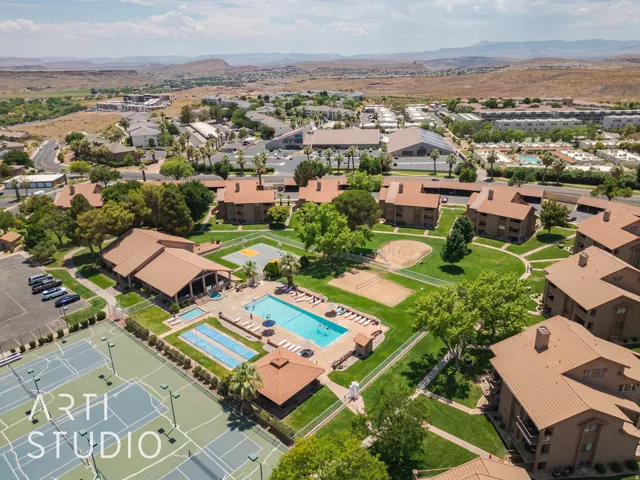 Aerial overview of property's location featuring a mountain backdrop and a pool area