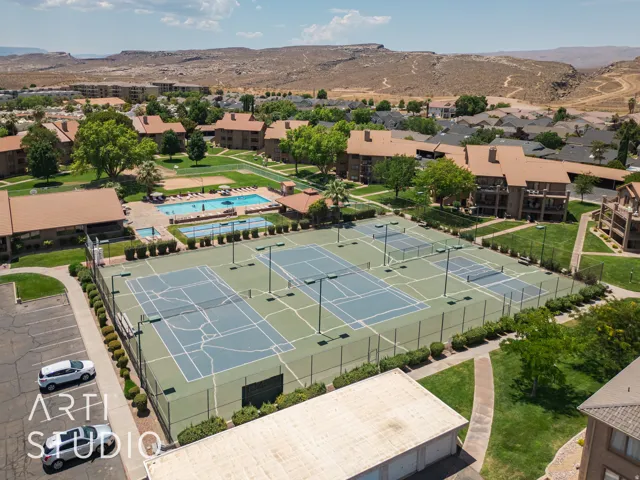 Drone / aerial view of a mountainous background and a pool