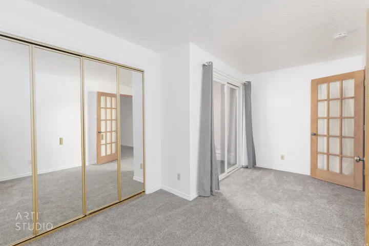 Unfurnished bedroom featuring light colored carpet, a closet, and a textured ceiling