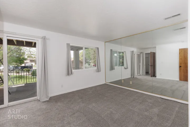 Unfurnished bedroom with carpet floors, a closet, access to exterior, and a textured ceiling