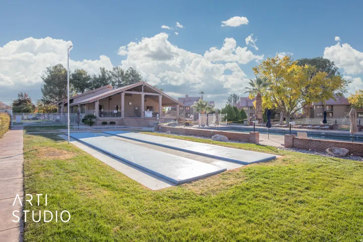 View of home's community featuring shuffleboard and a patio area