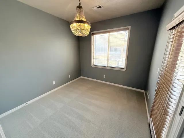 Unfurnished room with light carpet and baseboards