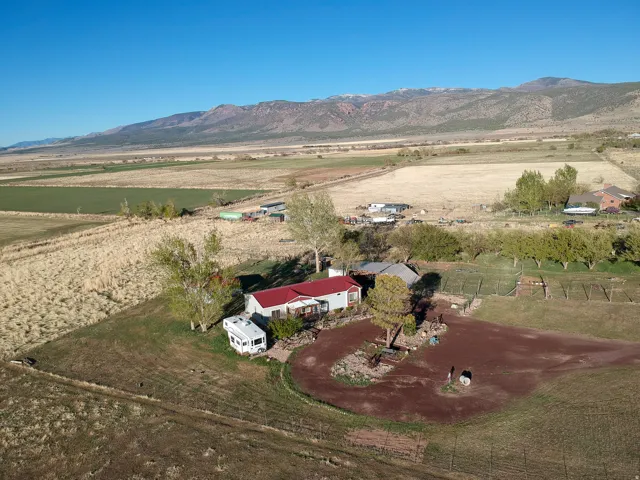 Aerial overview of property's location featuring rural landscape and mountains