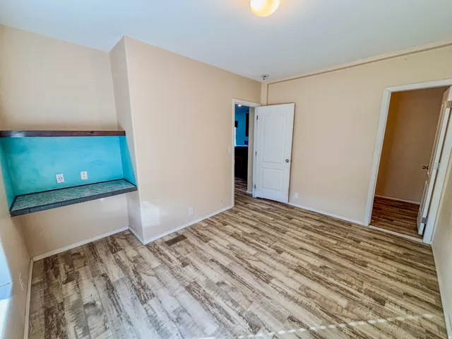 Unfurnished bedroom with light wood-type flooring and baseboards