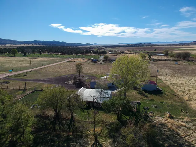 Aerial view of sparsely populated area featuring a pastoral area and mountains