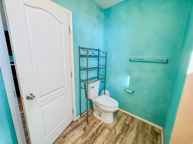 Bathroom featuring toilet and light wood-style flooring