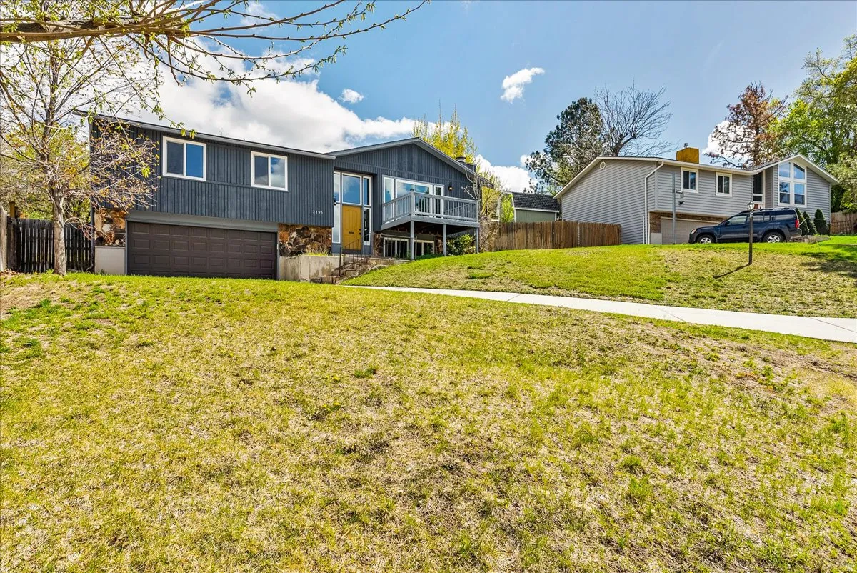 Back of property featuring a garage and a deck