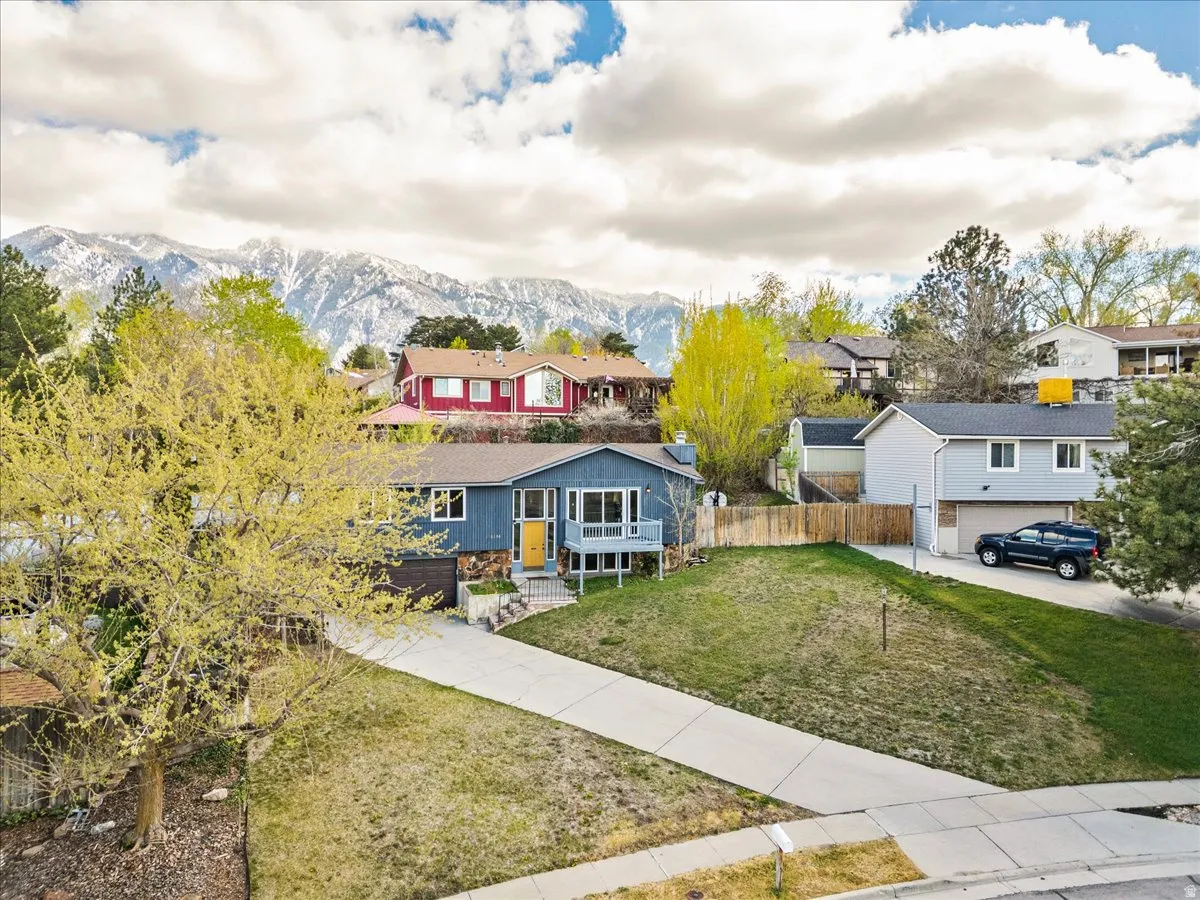 View of front of house featuring a residential view, a mountain view, and stone siding