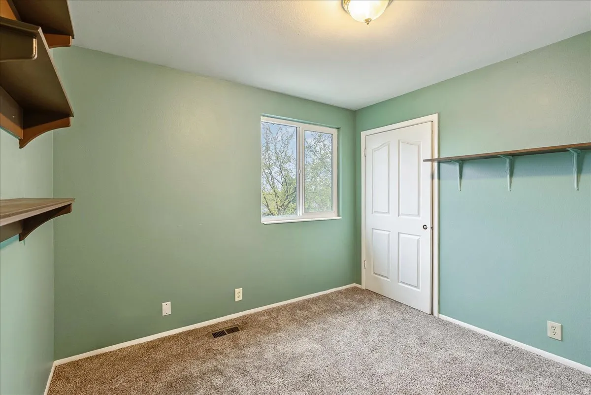 Unfurnished bedroom with carpet and a closet