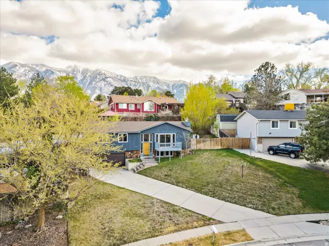 View of front of house featuring a residential view, a mountain view, and stone siding