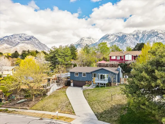 View of front of property with an attached garage, driveway, and a mountain view