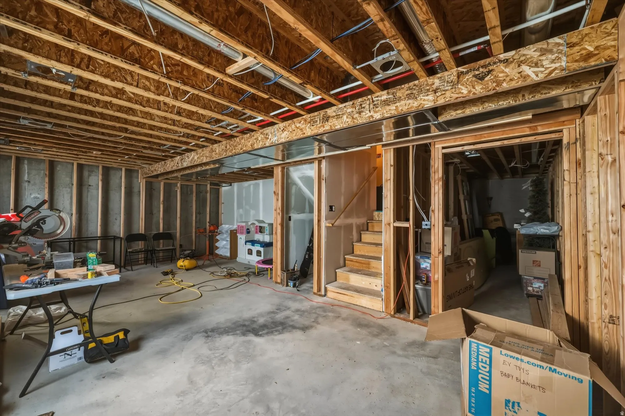 Unfinished below grade area featuring stairs