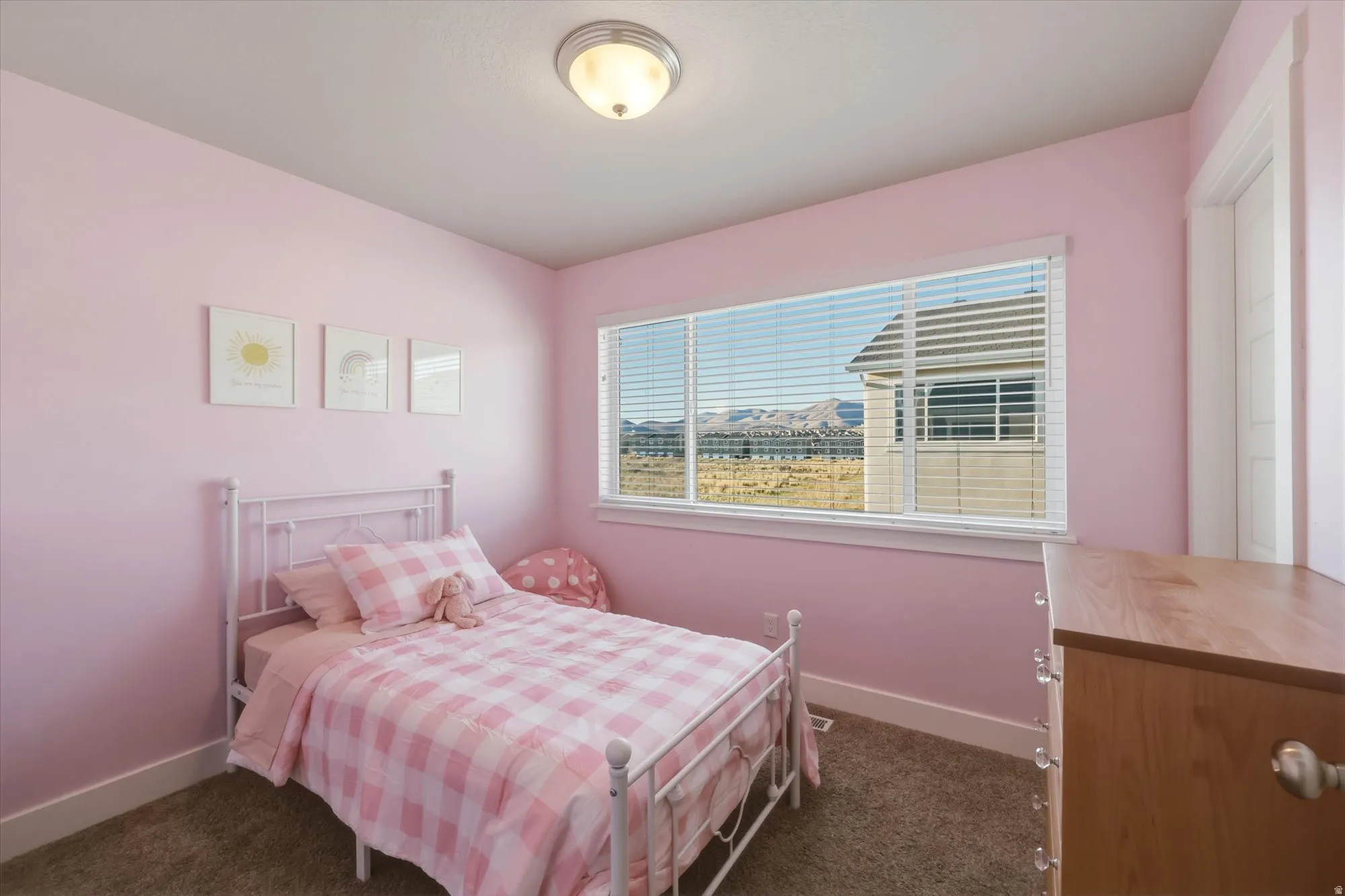 Bedroom with multiple windows and dark carpet