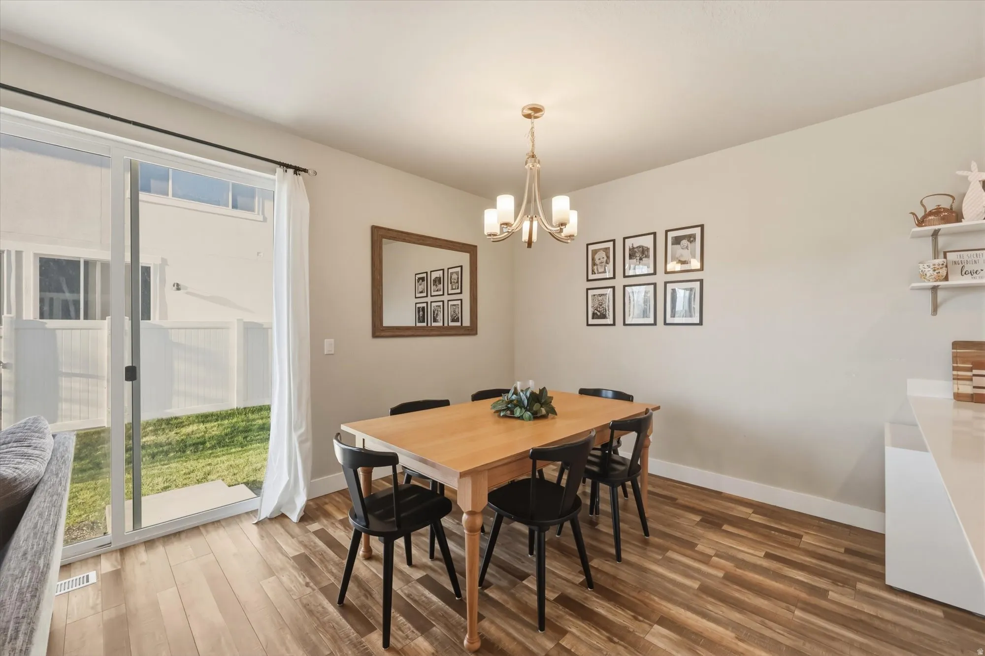 Dining room with wood finished floors and a chandelier