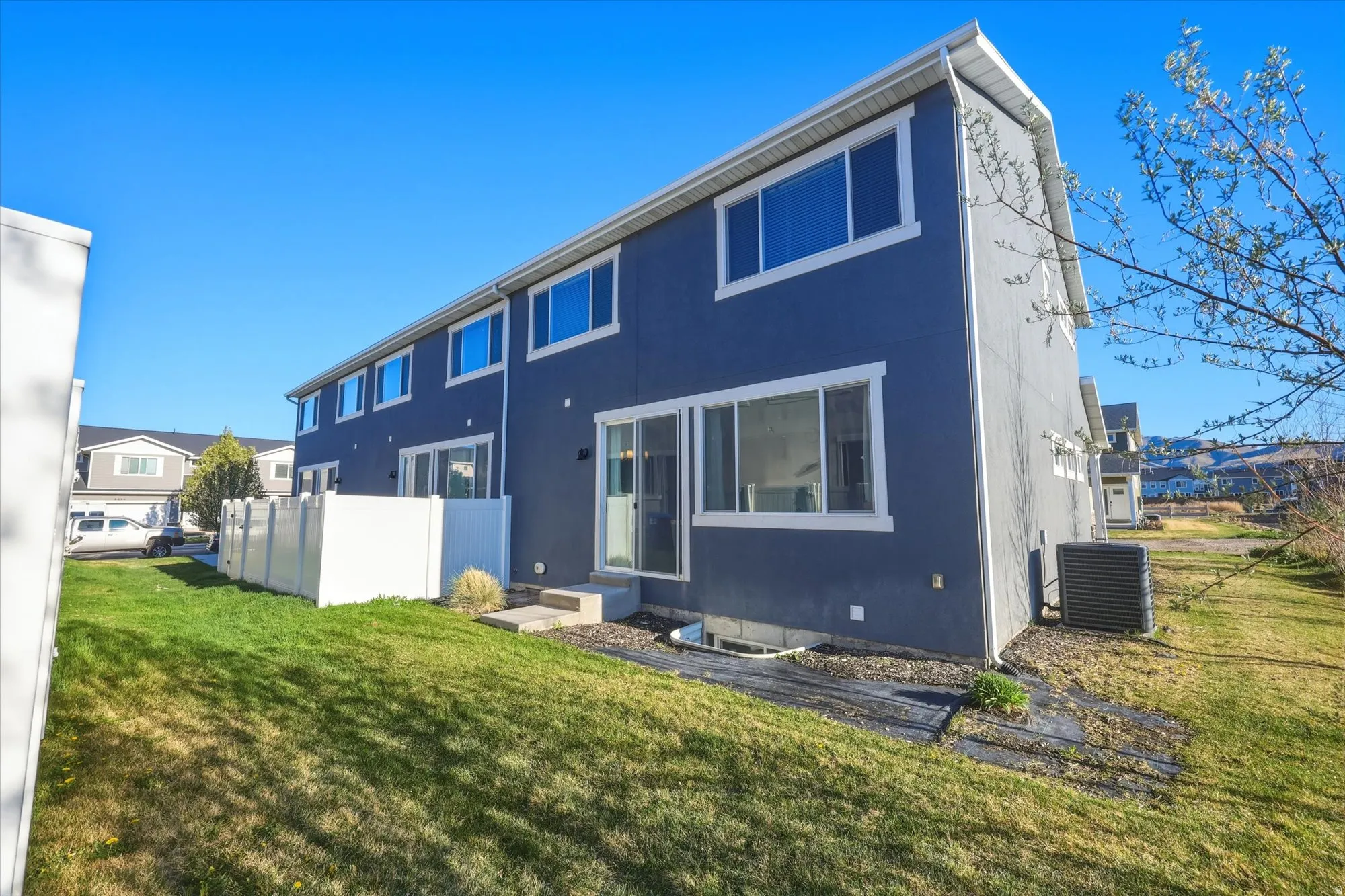 Back of property featuring stucco siding
