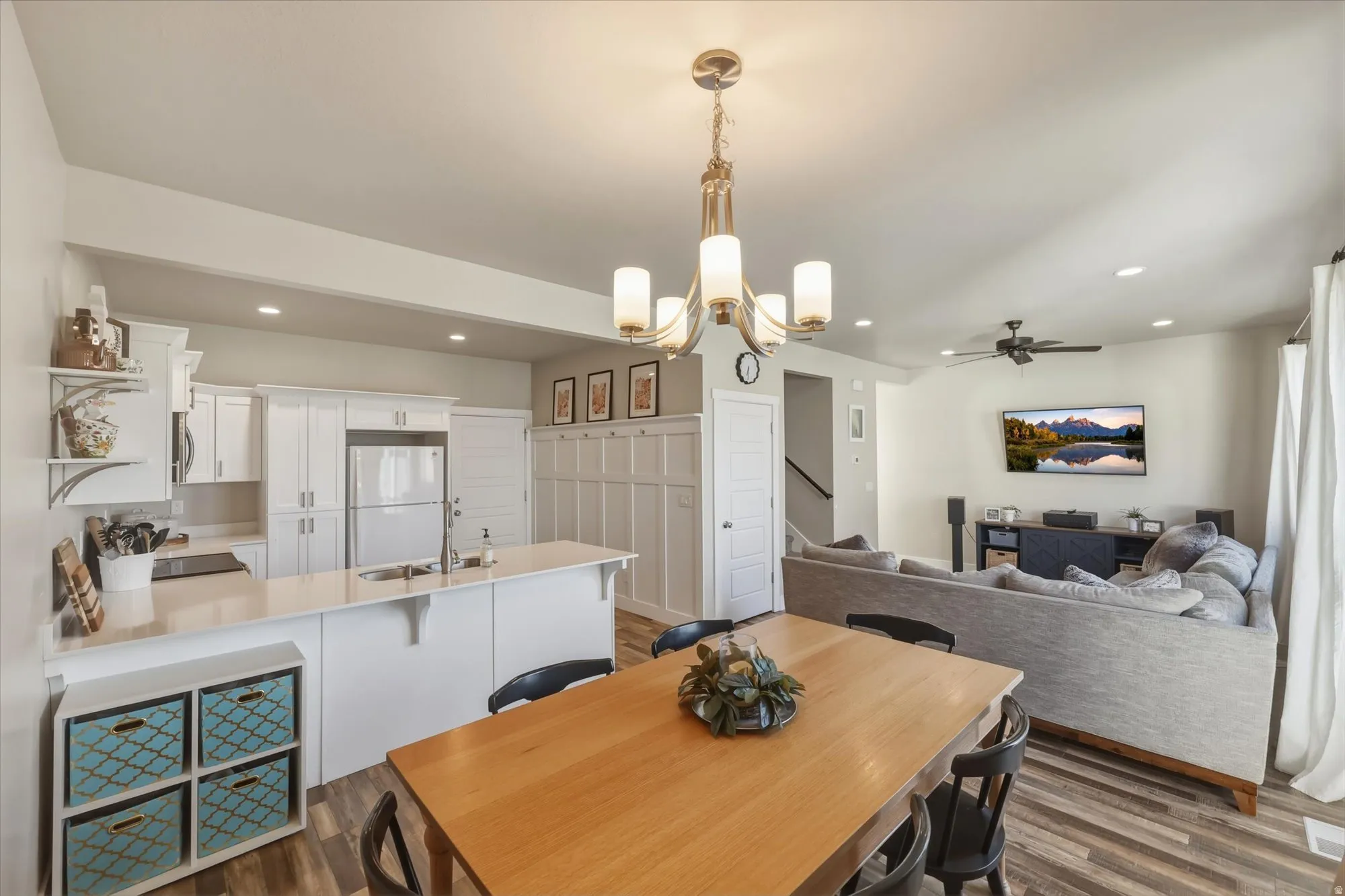 Dining space featuring hanging lights, a ceiling fan, and dark wood-type flooring
