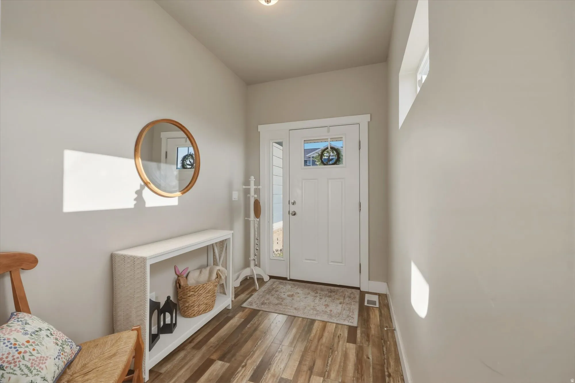 Foyer featuring dark wood-style flooring and baseboards