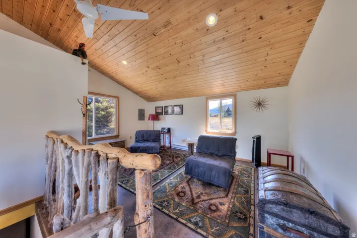 Living room featuring a vaulted wooden ceiling, recessed lighting, and ceiling fan