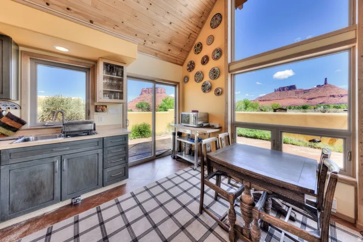 Dining space featuring a vaulted wooden ceiling, a mountain view, and dark tile patterned floors
