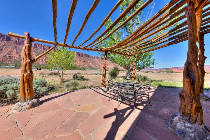 View of patio / terrace with outdoor dining area, a mountain view, and a pergola