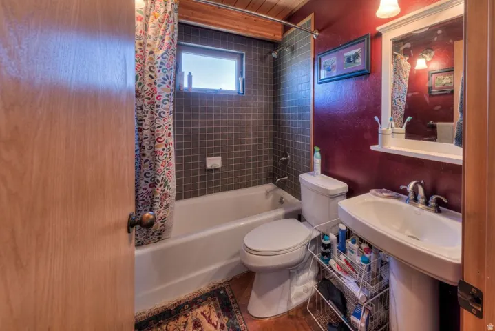 Full bathroom with toilet and shower / tub combo