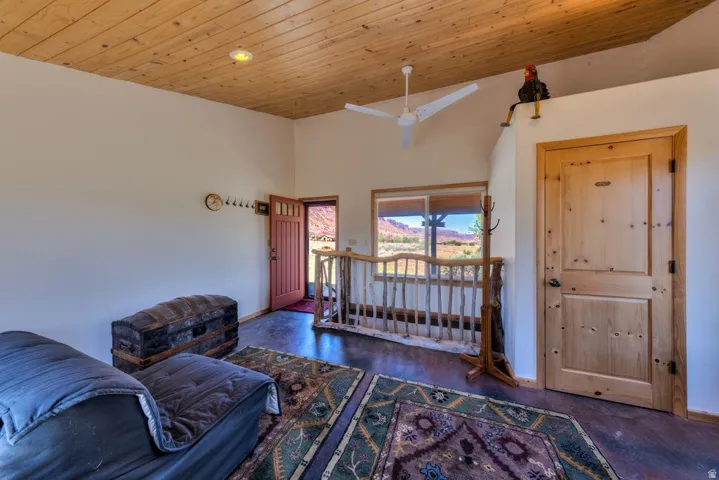 Living area featuring a high wooden ceiling and a skylight