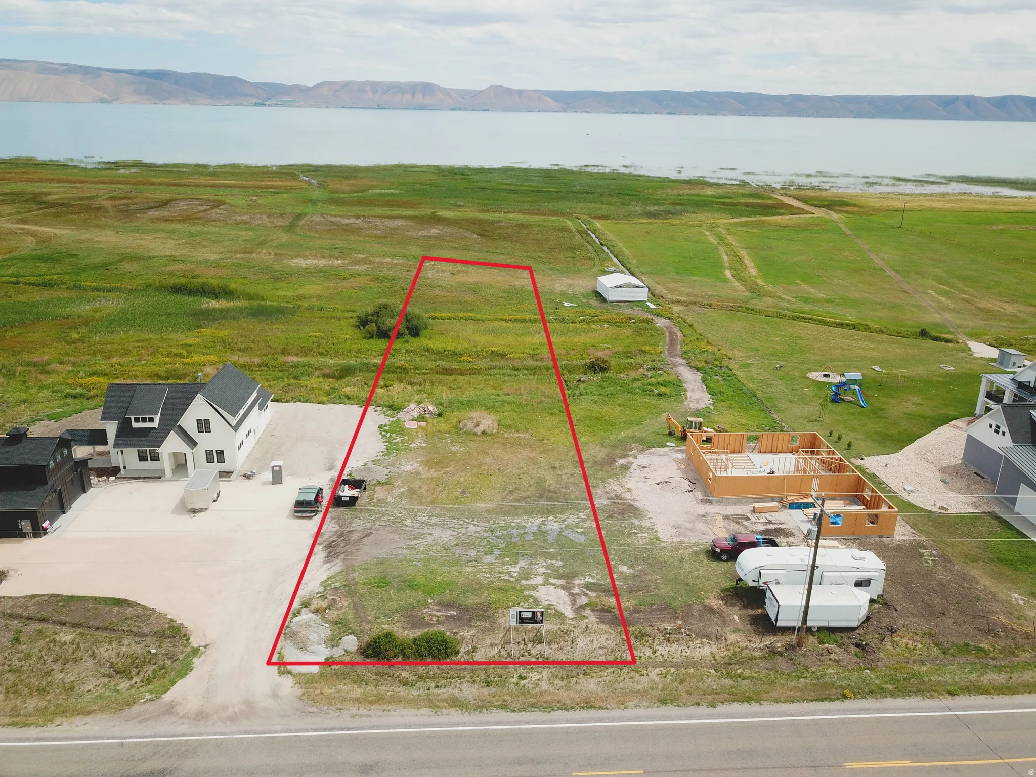 Overview of rural landscape featuring a water and mountain view and property boundaries highlighted