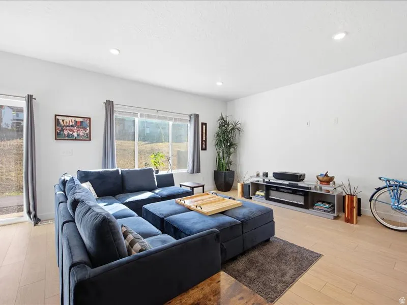 Living room featuring LVP flooring, open floor plan and tons of natural light.