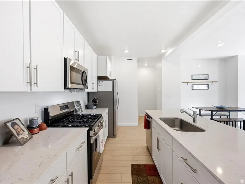 Kitchen featuring stainless steel appliances, quartzite countertops, breakfast island and Pantry