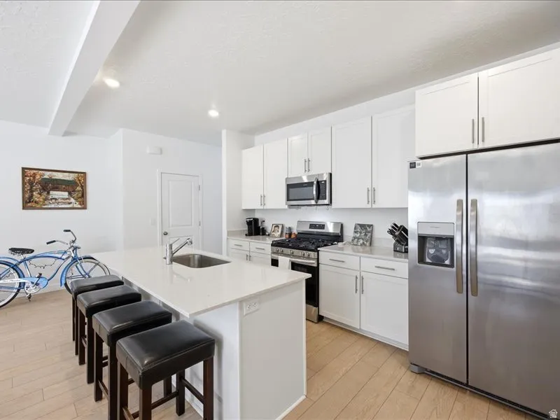 Kitchen featuring stainless steel appliances, quartzite countertops, breakfast island and Pantry