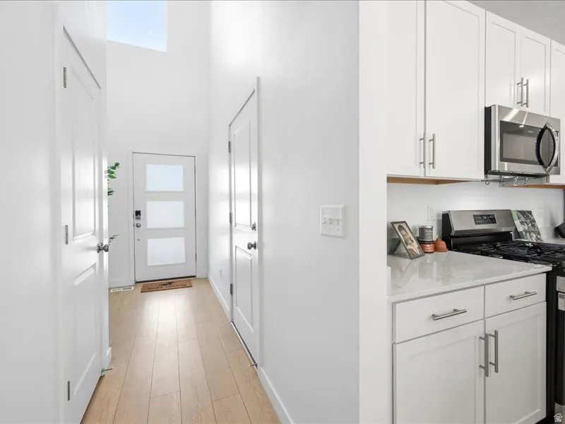 Entry with coat closet and room for bench and hooks.