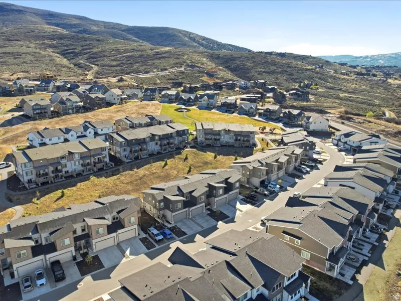 Aerial view of property's location with nearby suburban area and mountains