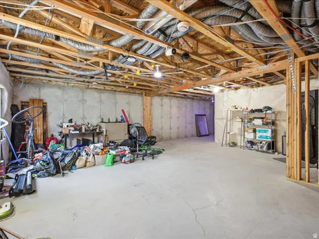 View of unfinished basement plumbed for bathroom