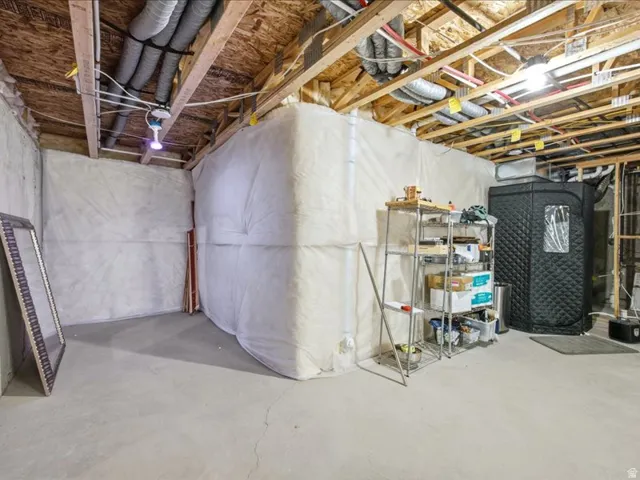 View of unfinished basement plumbed for bathroom