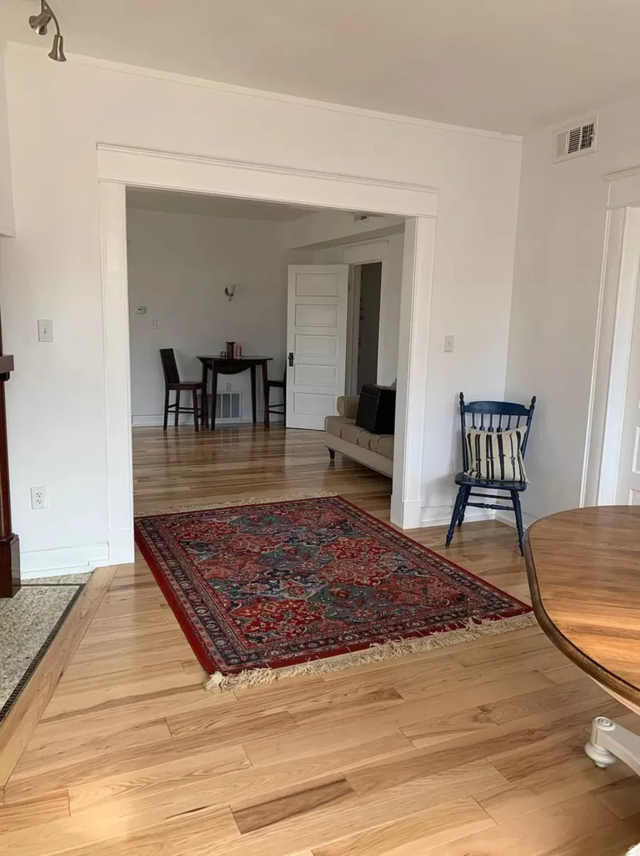 Corridor with light wood-style flooring and baseboards