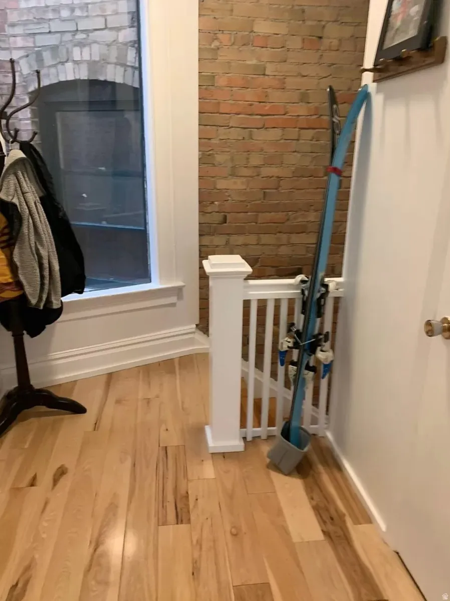 Interior space featuring wood finished floors and brick wall