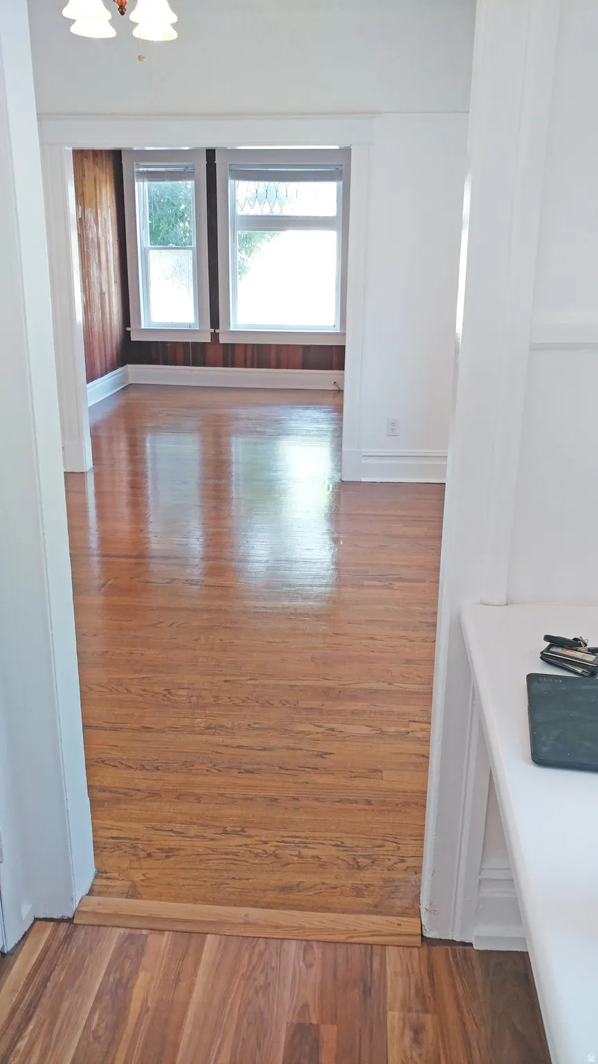 Corridor with dark wood finished floors and baseboards
