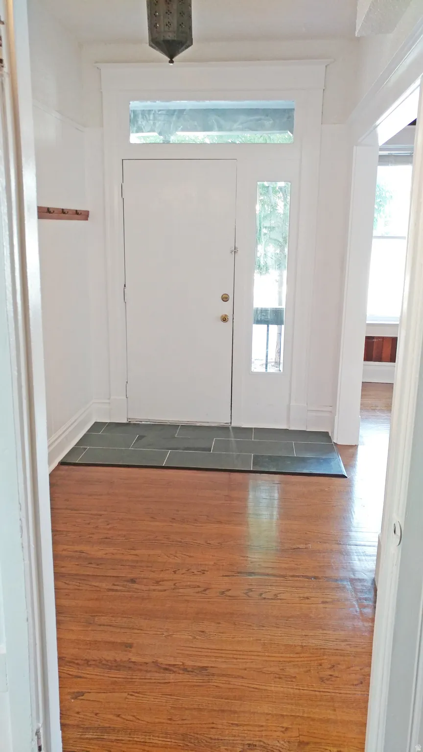 Foyer entrance with dark wood-style floors