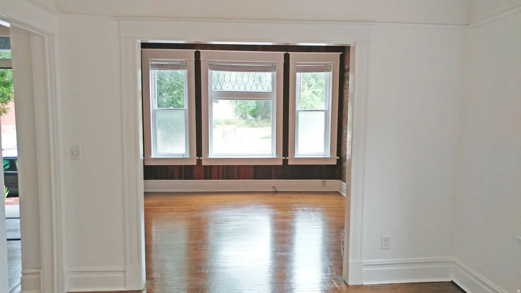 Spare room with wood finished floors and healthy amount of natural light