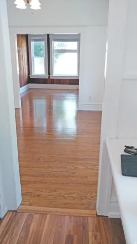 Corridor with dark wood finished floors and baseboards