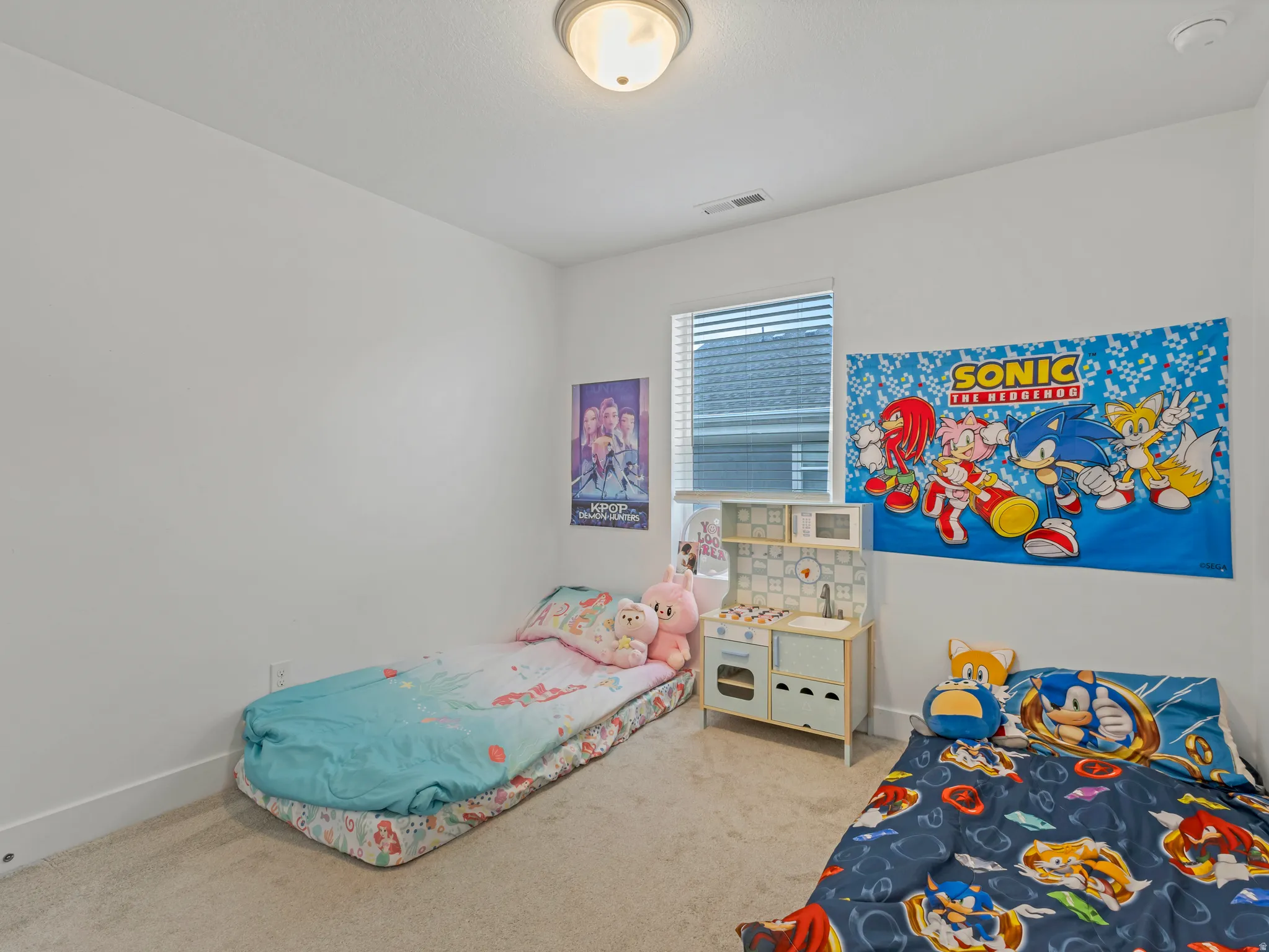 Bedroom with light colored carpet and baseboards