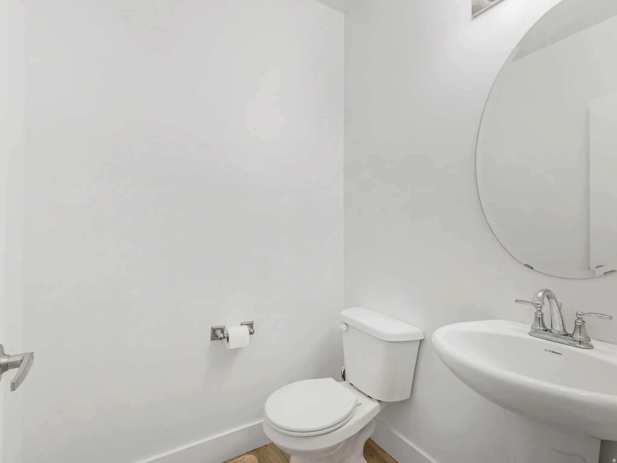 Bathroom with toilet and wood finished floors