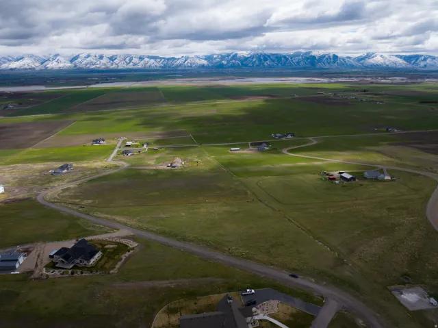 View of rural area featuring a mountain backdrop and rows of crops