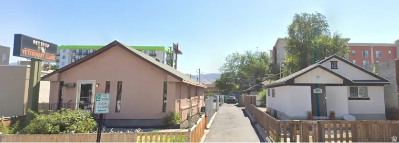 Two single-story structures featuring gabled roofs and distinct exterior finishes