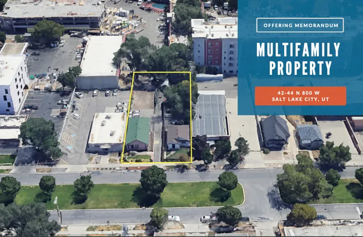 Multifamily property site bordered by a public road and mature trees