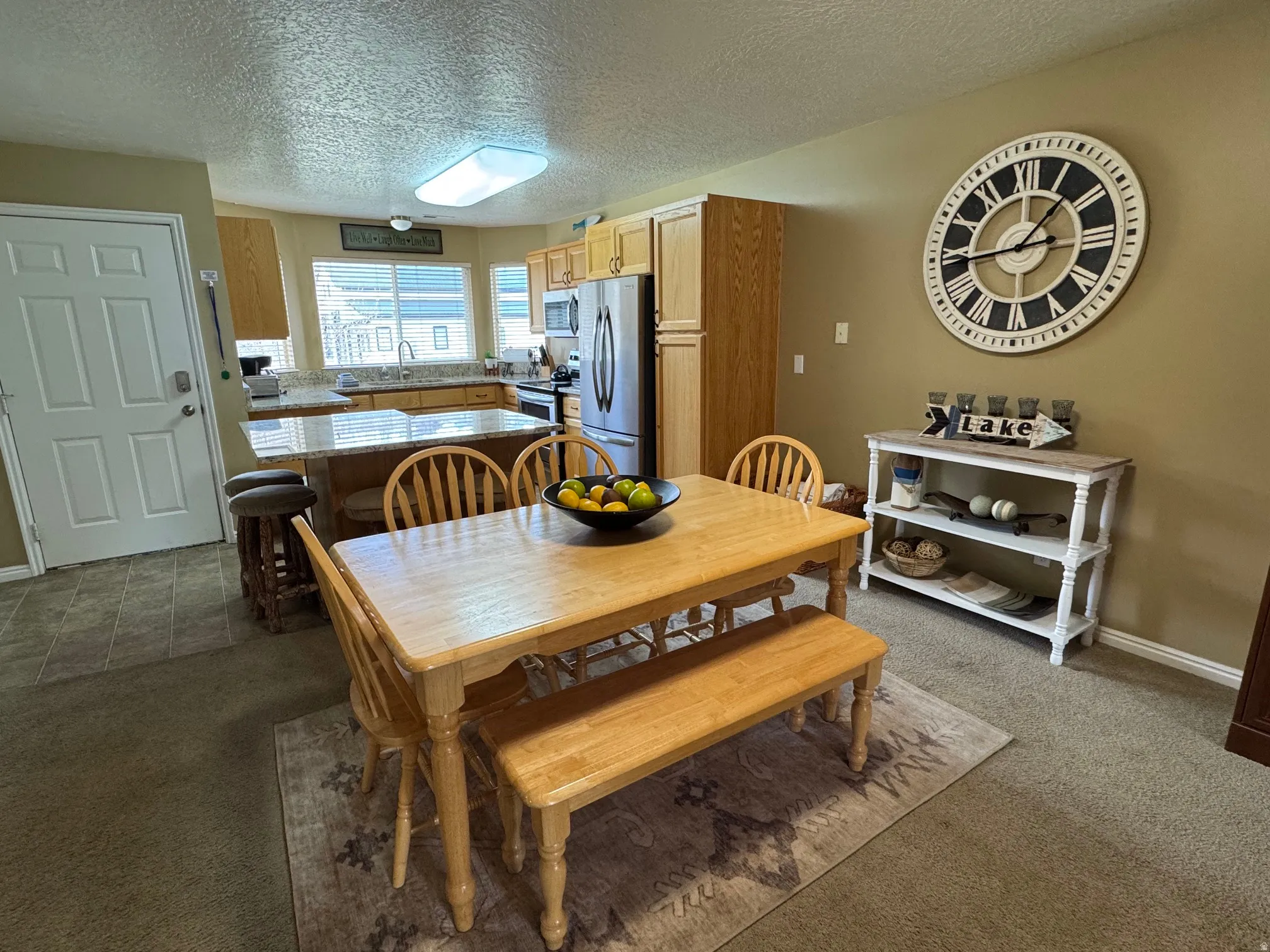 Dining space with dark colored carpet and a textured ceiling
