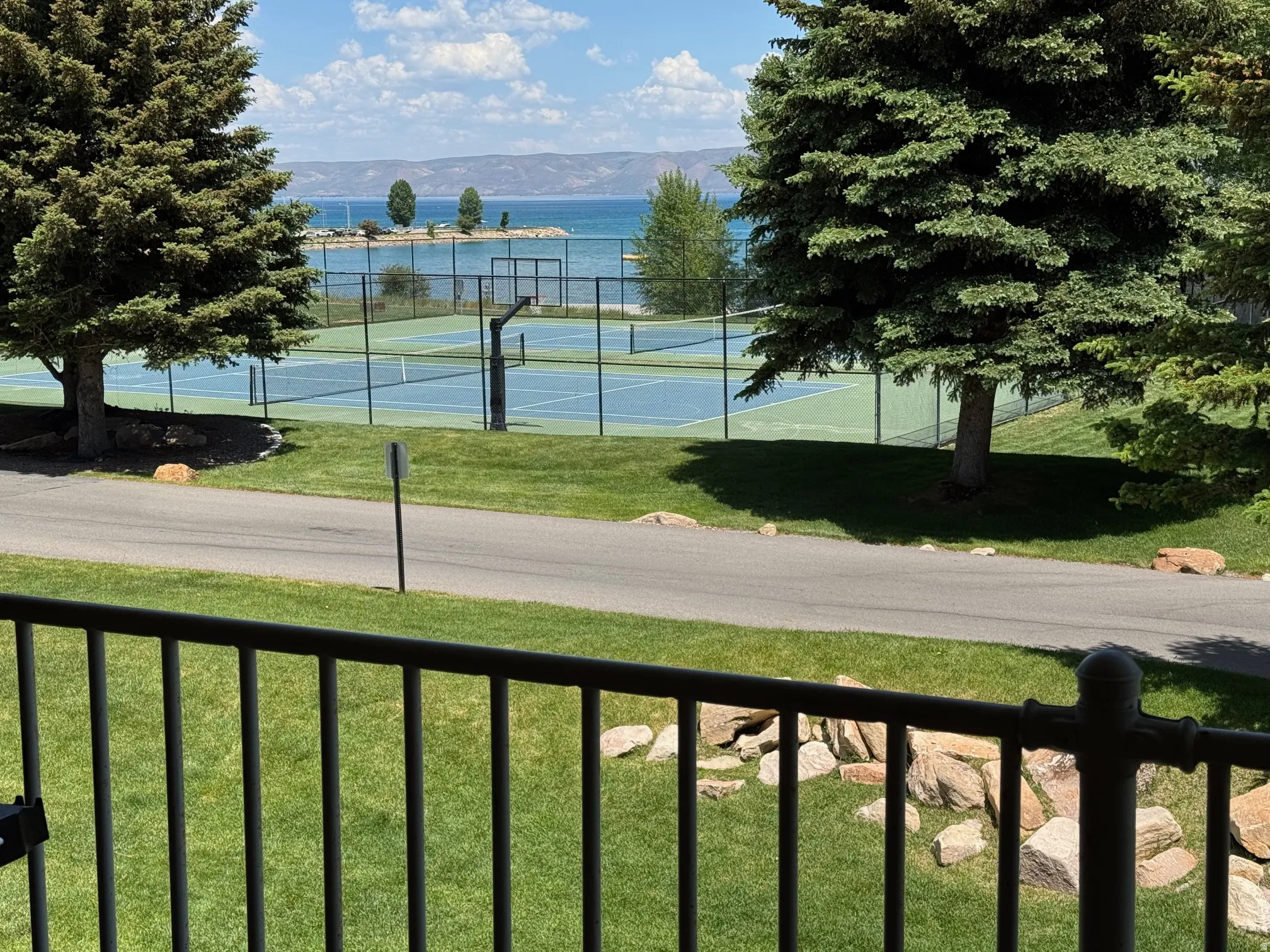 View of tennis court featuring a mountain view